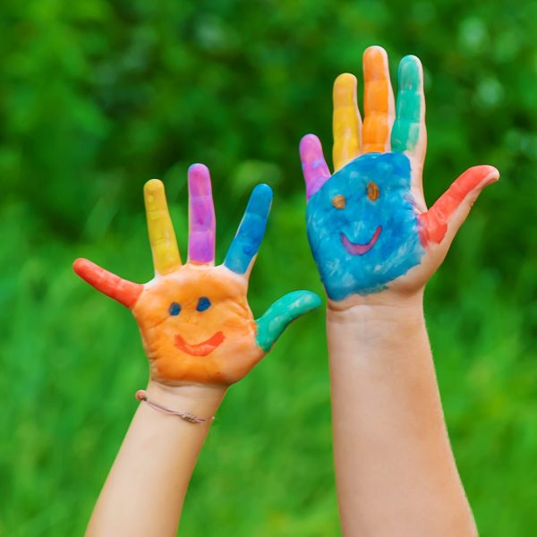 children-s-colorful-painted-hands-raised-in-green-2026-01-06-10-32-10-utc